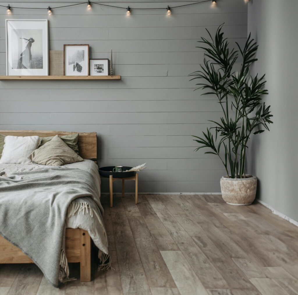 beautiful rustic bedroom with a wood floor and large pot plant