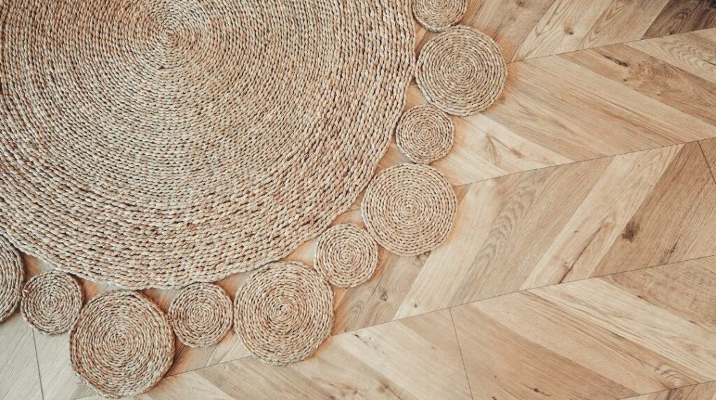 jute rug, light oak wooden flooring, just weaved rug, circular design rug.